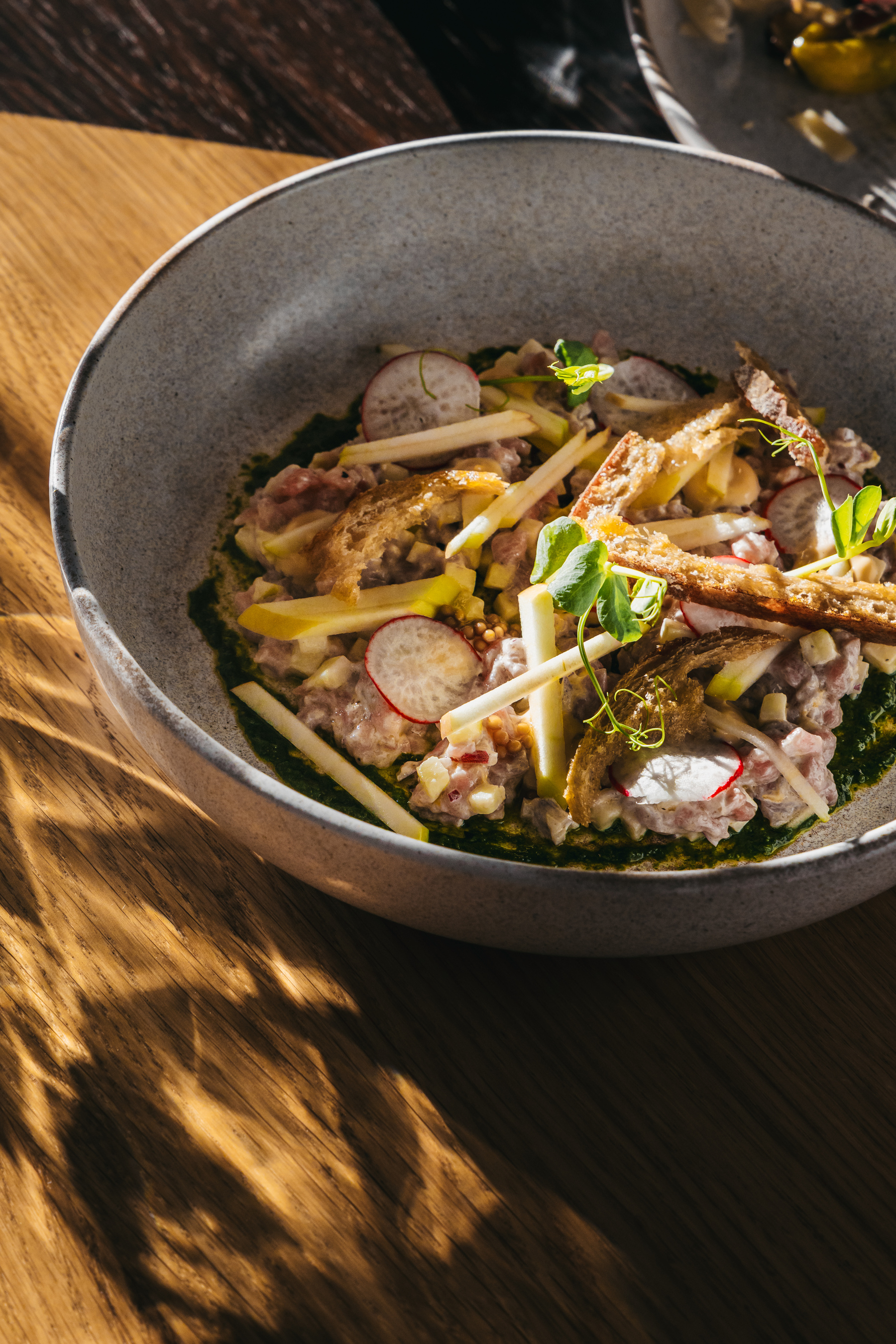 Kalbstartar mit Kräuterpesto und pochierten Apfelspalten  bei Salzburg schmeckt